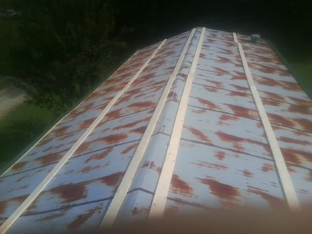Rusted metal roof panels with new wood purlins before replacement — Storm Damage Roof Repair in Fort Stewart by Roofing Brothers